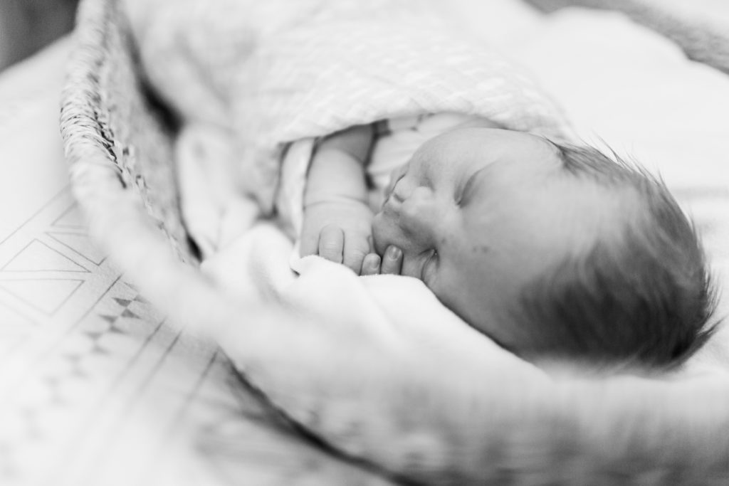 Boston Newborn Photographer - Newborn baby swaddled and sleeping in a moses basket in Holliston, Massachusetts