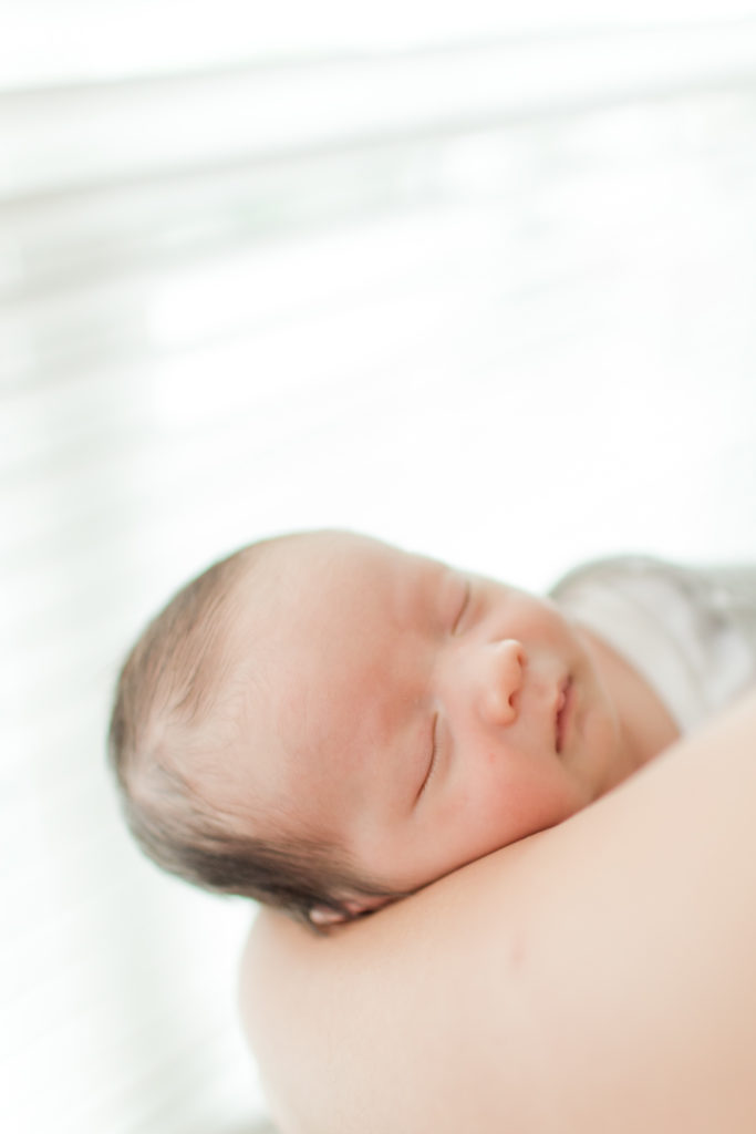 Boston newborn photographer -  newborn baby sleeping in mom's arms