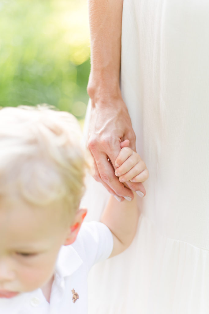 Metrowest Family Photographer close up photo of mom and toddler holding hands