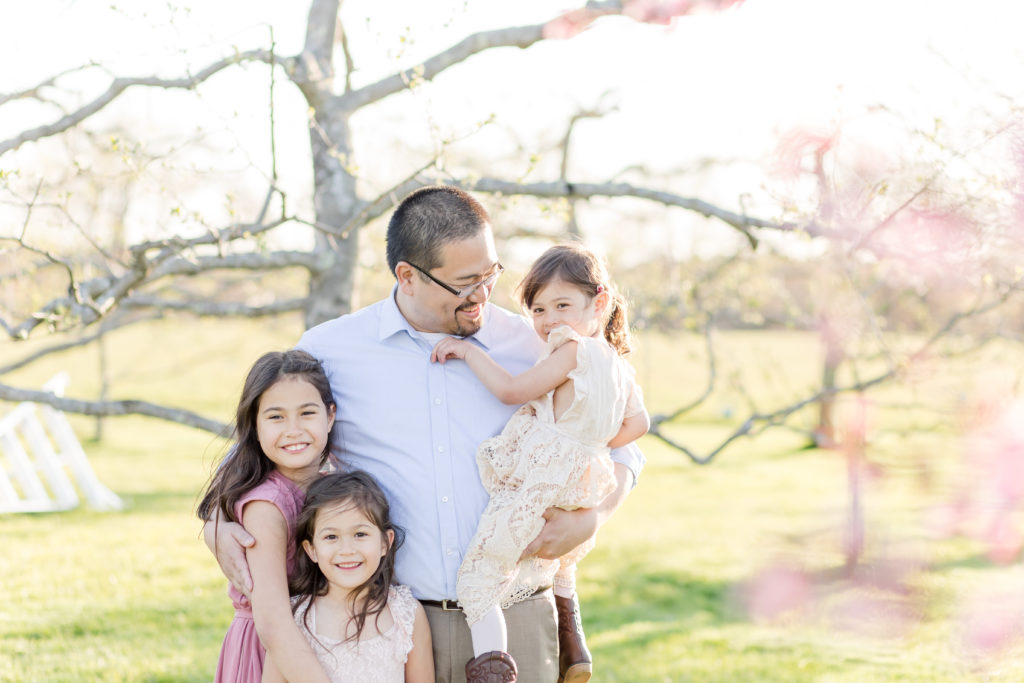 Boston dad embracing his daughters during a photo session with Corinne Isabelle Photography