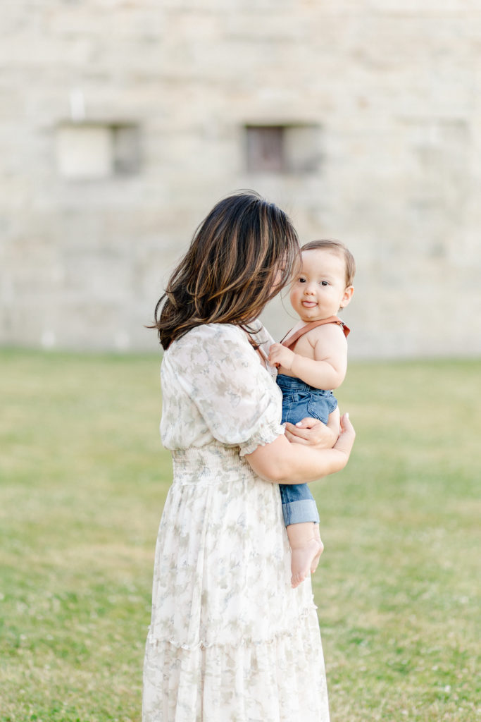 Young mom holding her son during their 1 year old Boston baby photography session at Castle Island