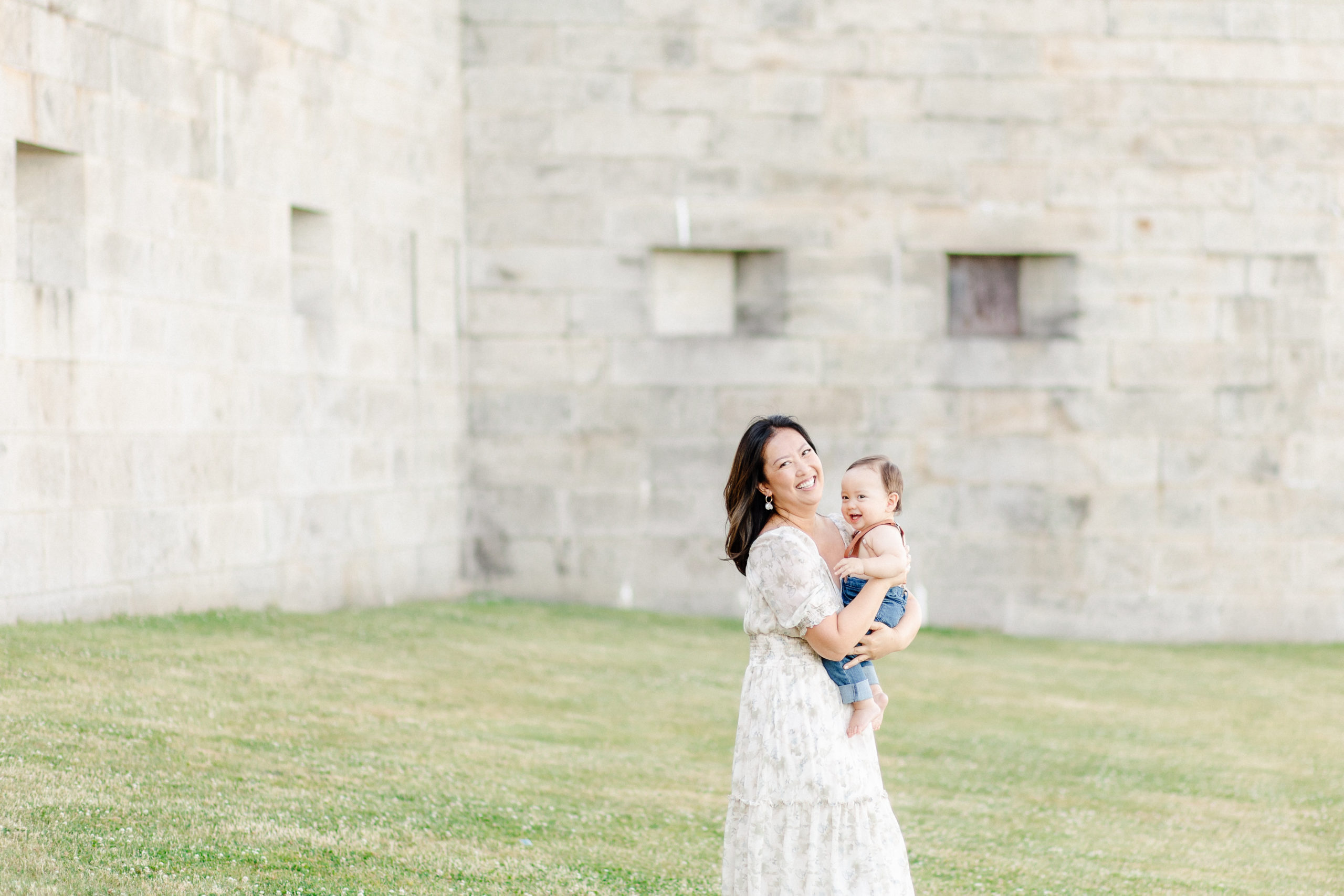 Young mom holding her son during their 1 year old Boston baby photography session at Castle Island