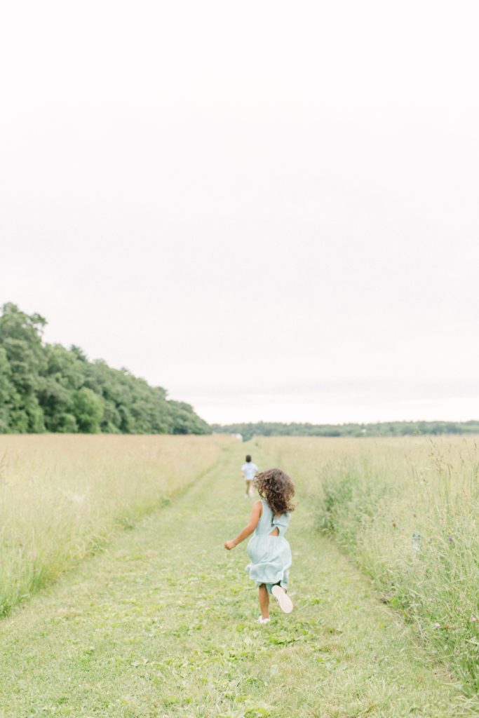 Young kids running around outdoors during a lifestyle family session with Boston Family Photographer Corinne Isabelle