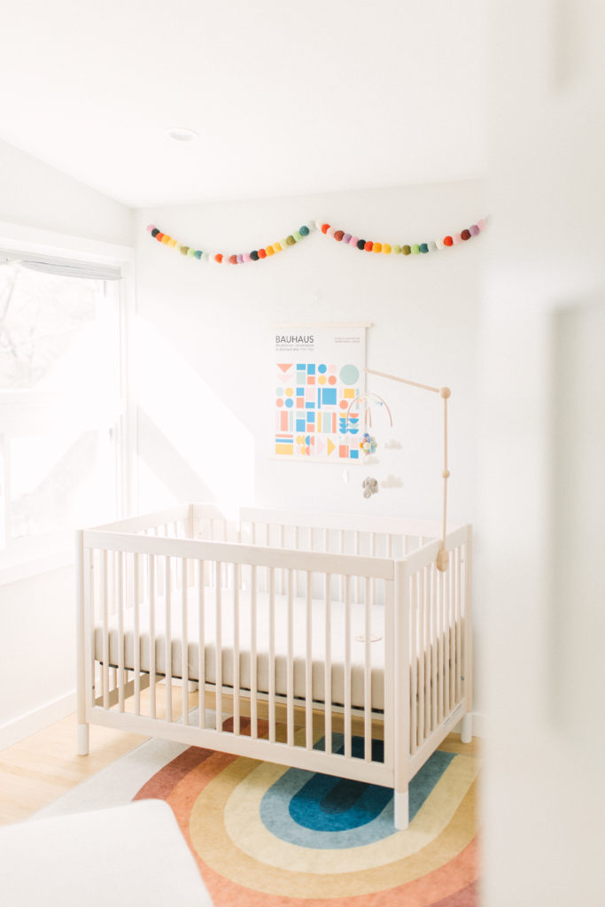 Glimpse into the nursery of a newborn baby with rainbow accents during photo session with Framingham Newborn Photographer Corinne Isabelle