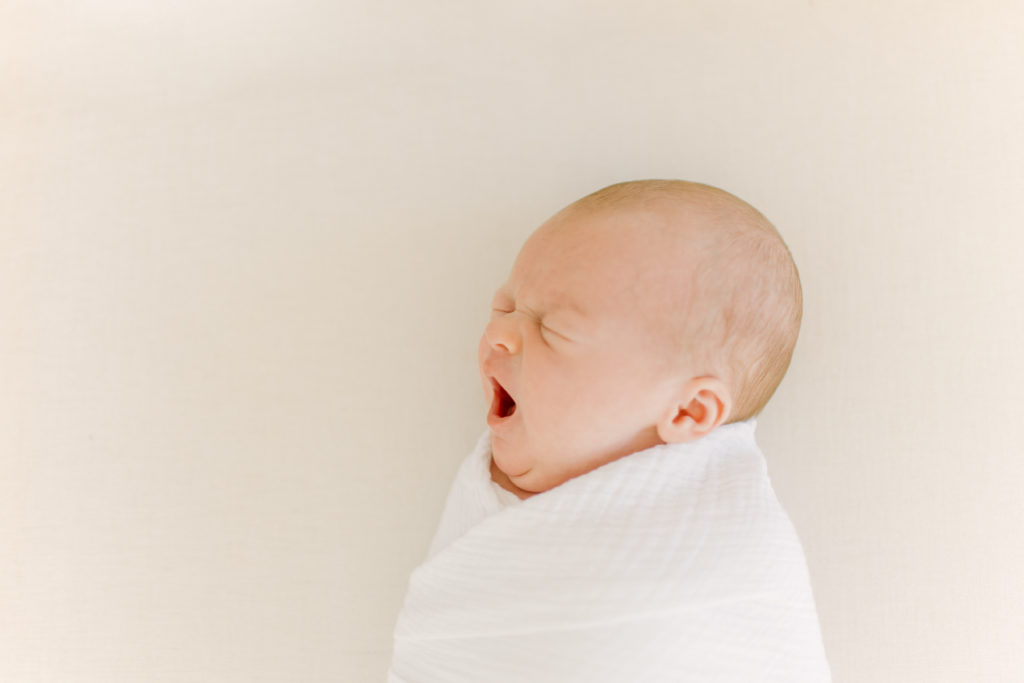 Newborn baby yawning during photo session with Medway Newborn Photographer Corinne Isabelle