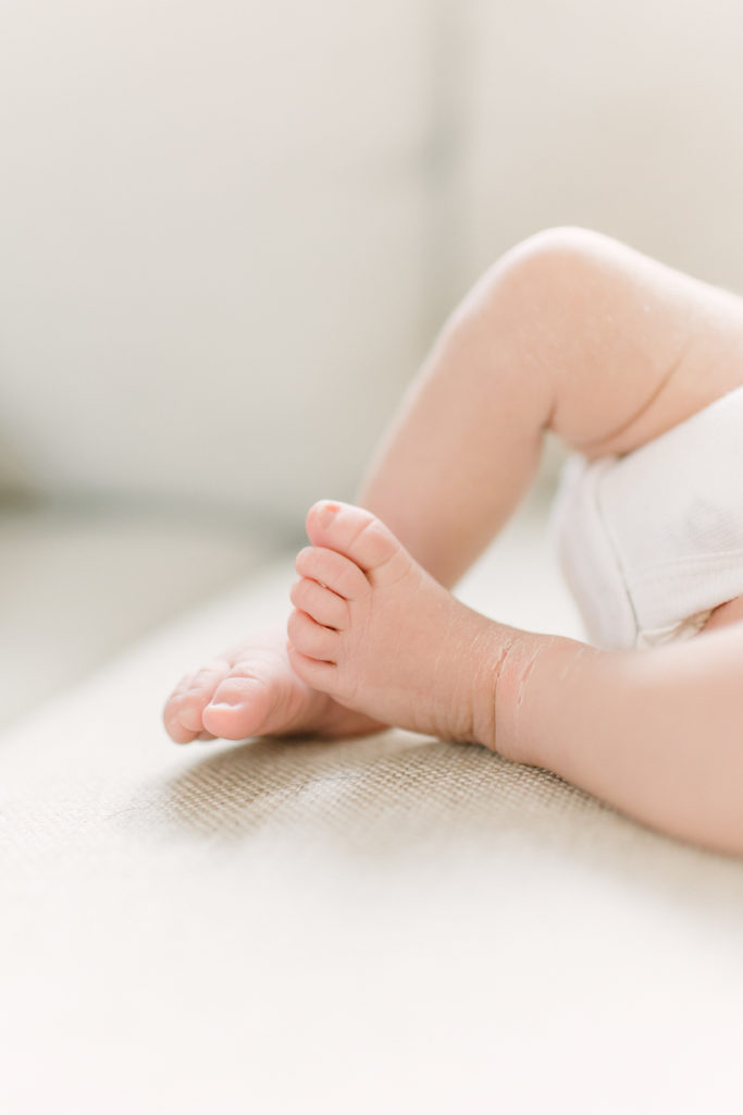 Close up of newborn baby toes during photo session with Natick newborn photographer Corinne Isabelle