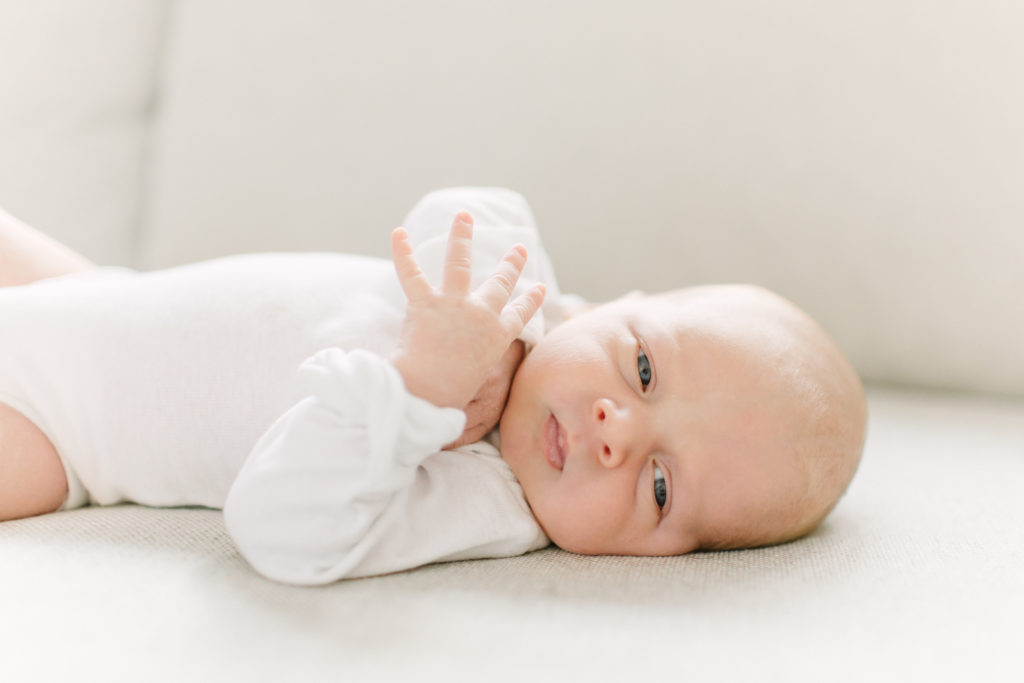 Close up of newborn baby boy laying on his side during photo session with Natick newborn photographer Corinne Isabelle