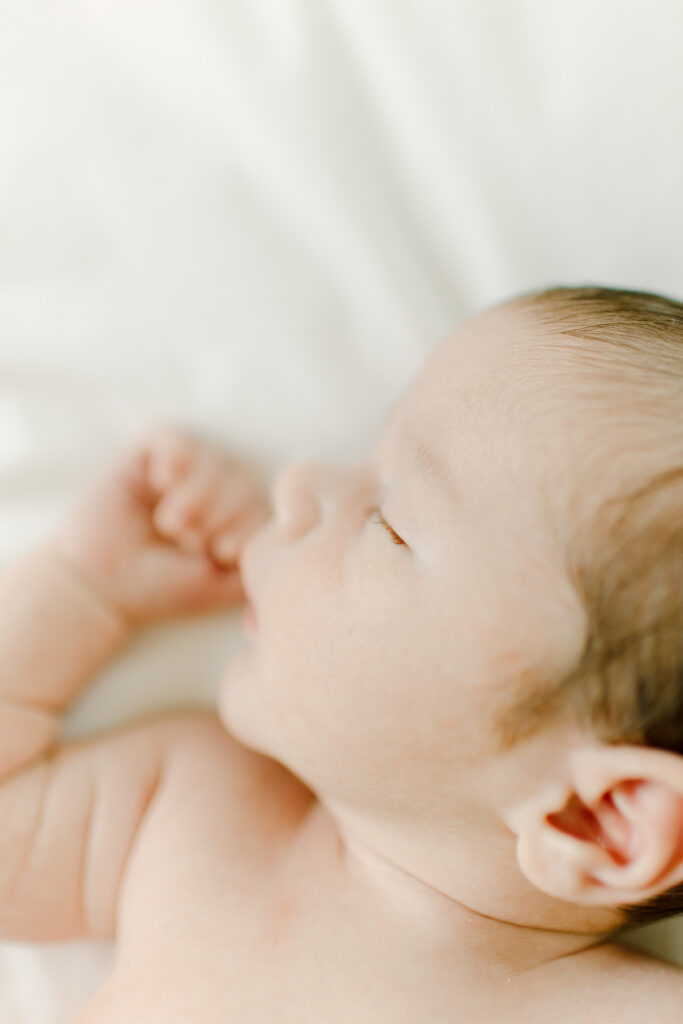 Close up of newborn baby boy during photo session with Boston newborn photographer Corinne Isabelle
