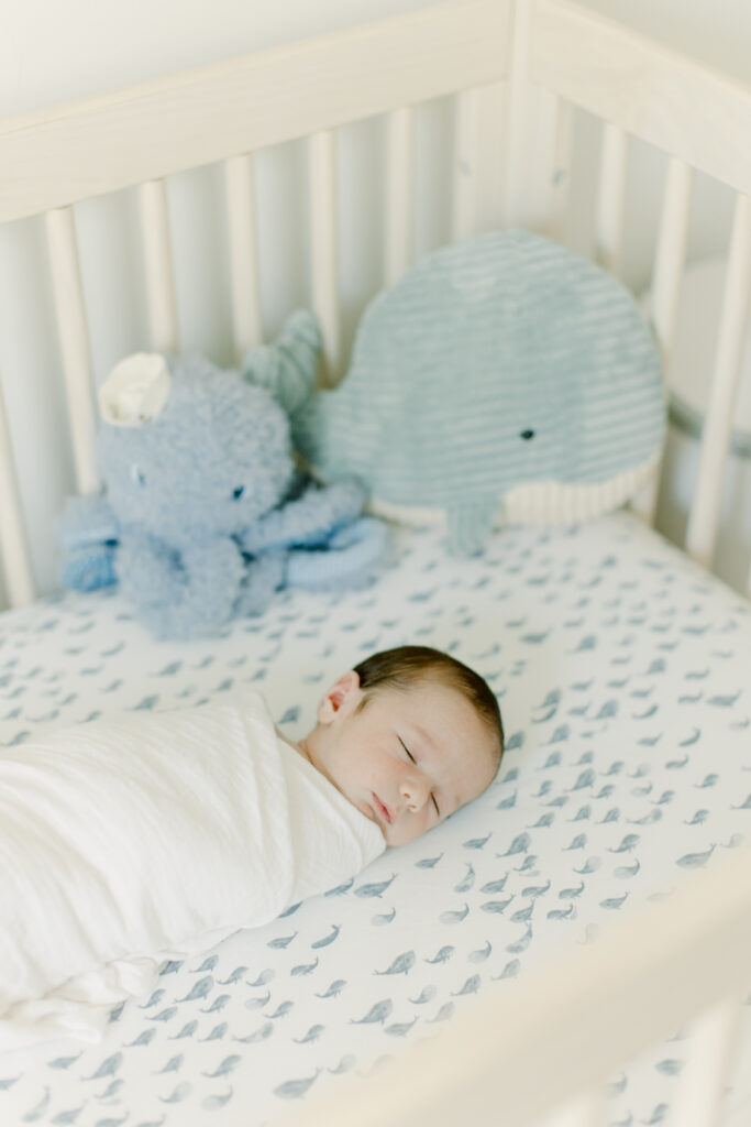 baby boy sleeping in crib during in-home photo session with Boston newborn photographer Corinne Isabelle